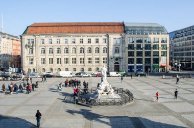 BERLIN, GERMANY, MARCH 12, 2015: people are walking through famous gendarmenmarkt in berlin famous for buildings of deustcher dom, french friedrichstadt church and konzerthaus berlin.