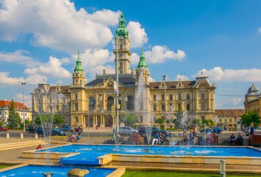 GYOR, HUNGARY MAY 20, 2016: People are sitting around a singing fountain situated in front of the town hall in the hungarian city Gyor.