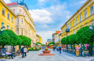 GYOR, HUNGARY 20 Mayıs 2016: Macaristan 'ın eski kentinde insanlar dar bir sokakta yürüyorlar.