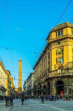 BOLOGNA, ITALY, 17 Mart 2016: İnsanlar Franco Rizzoli üzerinden Bologna 'nın iki kulesine doğru yürüyor - Torre Garisenda ve Torre Degli Asinelli