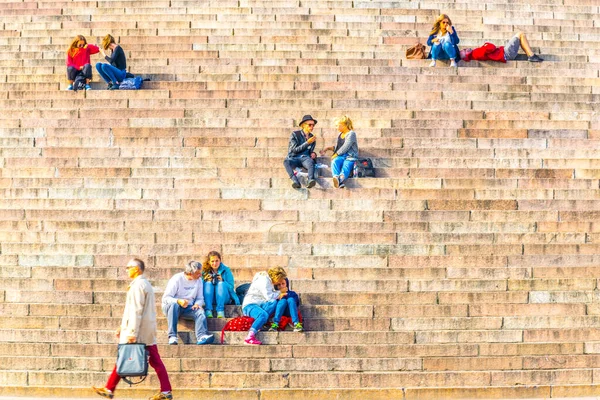 HELSINKI, FINLAND, AĞUSTOS 17 Ağustos 2016: İnsanlar Finlandiya 'daki Helsinki katedralinin önündeki merdivenlerde oturuyorlar.