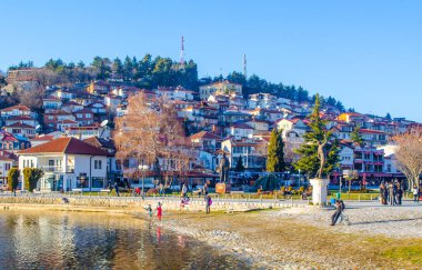 OHRID, FEBRUARY 14, 2015: İnsanlar güneşli bir günde ohrid gölünün yanındaki gölde geziniyorlar.