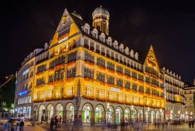 MUNICH, GERMANY, AUGUST 20, 2015: Exterior view of Hirmer during night, the largest men's fashion house in the world
