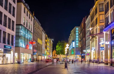 MUNICH, GERMANY, AUGUST 20, 2015: People are walking though illuminated Neuhauser Street towards Karlsplatz Gate in Munich at the Evening, Germany