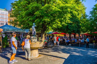 MUNICH, GERMANY, AUGUST 20: People at the Viktualienmarkt in Munich, Germamy. This traditional market takes place every day since 1807 . clipart
