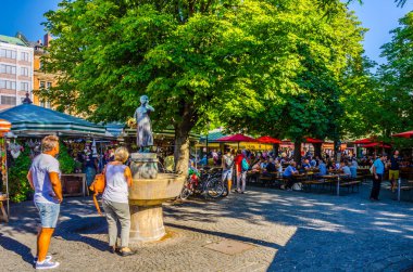 MUNICH, GERMANY, AUGUST 20: People at the Viktualienmarkt in Munich, Germamy. This traditional market takes place every day since 1807 . clipart