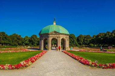 MUNICH, GERMANY, AUGUST 25, 2015: people are walking towards the temple of diana situated inside of the hofgarten in german city munich