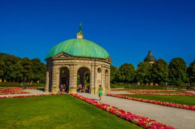 MUNICH, GERMANY, AUGUST 25, 2015: people are walking towards the temple of diana situated inside of the hofgarten in german city munich