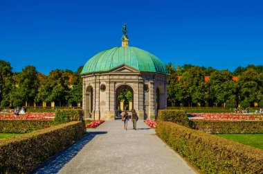 MUNICH, GERMANY, AUGUST 25, 2015: people are walking towards the temple of diana situated inside of the hofgarten in german city munich