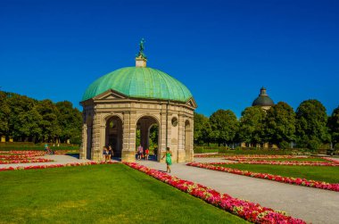 MUNICH, GERMANY, AUGUST 25, 2015: people are walking towards the temple of diana situated inside of the hofgarten in german city munich