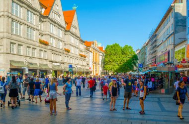 MÜZİK, GERMANY, 20 AĞUSTOS 2015: İnsanlar Münih 'teki Karlsplatz Kapısı' na doğru aydınlanmış Neuhauser Caddesi 'nde yürüyorlar.