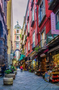 NAPLES, ITALY, MAY 8, 2014: People are passing by through narrow streets of historical old town in italian naples.