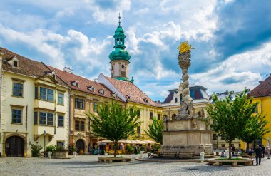 SOPRON, HUNGARY, 18 HAZİRAN 2016: Fo ter - Macar şehri Sopron 'un ana meydanı Kutsal Üçleme sütunu ve ünlü yangın kulesi