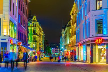 OSLO, NORWAY, AUGUST 24, 2016: People are strolling on a street during night in Oslo, the capital of Norway