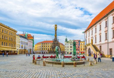 OLOMOUC, CZECH REPUBLIC, APRIL 16, 2016: View of a turtle statue next to the arion fountain in the czech city Olomouc with holy trinity column behind it.