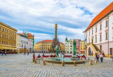 OLOMOUC, CZECH REPUBLIC, APRIL 16, 2016: View of a turtle statue next to the arion fountain in the czech city Olomouc with holy trinity column behind it.