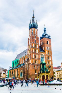 KRAKOW, POLAND, 11 AĞUSTOS 2016: Polonya 'nın Krakow / Krakow kentindeki Aziz Mary Kilisesi' nin önünden insanlar geçiyor.