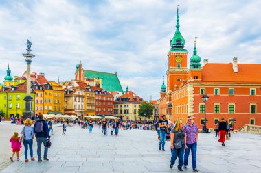 WARSAW, POLAND, AUGUST 12, 2016: People are walking over the castle square in front of the royal castle and sigismund s column in Warsaw, Poland.
