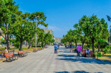 GIOVINAZZO, ITALY, JUNE 13, 2014: People are sitting in a park in the italian town giovinazzo