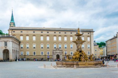SALZBURG, AUSTRIA, JULY 3, 2016: Beautiful view of Residenzplatz with the cathedral and Residenzbrunnen fountain in the historical part of the Austrian city Salzburg.