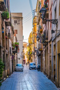 TARRAGONA, SPAIN, DECEMBER 29, 2015: people are walking through the main shopping street in the historical center of spanish city tarragona - carrer major