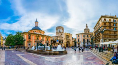 VALENCIA, SPAIN, DECEMBER 30, 2015: Square of Saint Mary's with Valencia Cathedral Temple, Basilica de la nuestra senora de los desamparados and the rio tura fountain in old town.