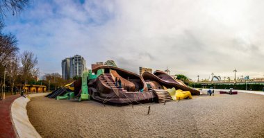 VALENCIA, SPAIN, DECEMBER 31, 2015: Children are playing at the gulliver playground situated inside of the turia gardens in valencia. clipart