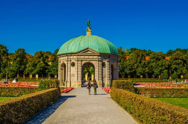 MUNICH, GERMANY, AUGUST 25, 2015: people are walking towards the temple of diana situated inside of the hofgarten in german city munich