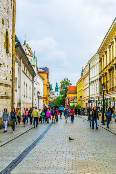 KRAKOW, POLAND, AUGUST 11, 2016: People are walking through Grodzka street towards the saint Andrew church in Krakow/Cracow, Poland.