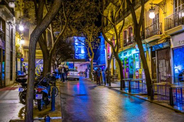 VALENCIA, SPAIN, DECEMBER 31, 2015: people are walking through a narrow street in the old town center of spanish city valencia.