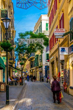 GIBRALTAR, GIBRALTAR, JANUARY 5, 2016: people are strolling through a narrow street of Gibraltar