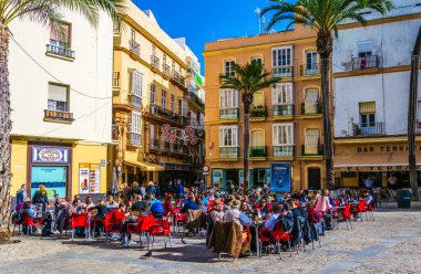 CADIZ, SPAIN, JANUARY 6, 2016: people are relaxing in a cafe on popular plaza de la catedral in cadiz