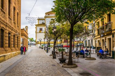 CADIZ, SPAIN, JANUARY 6, 2016: people are stolling through a narrow street in historical center of spanish city cadiz