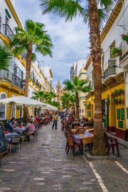CADIZ, SPAIN, JANUARY 6, 2016: people are enjoying lunch outside on the calle de la virgen in the spanish city cadiz