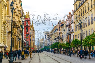 SEVILLA, SPAIN, JANUARY 7, 2016: İspanya 'nın Sevilla kentindeki avenida de la constitucion caddesinde Ocak ayında bulutlu bir günde insanlar geziniyor