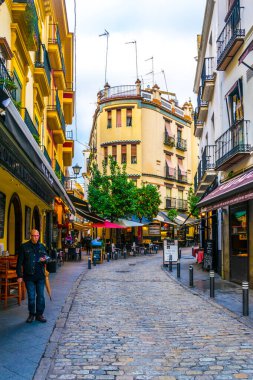 SEVILLA, SPAIN, JANUARY 7, 2016: people are stolling through a narrow street situated in the center of the spanish city sevilla