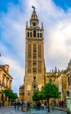 SEVILLA, SPAIN, JANUARY 7, 2016: İspanya 'nın Sevilla kentindeki la giralda kulesinin önünde insanlar geziniyor
