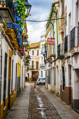CORDOBA, SPAIN, JANUARY 8, 2016: people are strolling through whitewashed streets of the jewish quarter of the spanish city cordoba