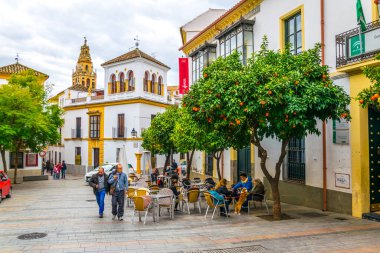 CORDOBA, SPAIN, JANUARY 8, 2016: people are strolling through whitewashed streets of the jewish quarter of the spanish city cordoba