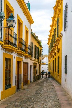 CORDOBA, SPAIN, JANUARY 8, 2016: people are strolling through whitewashed streets of the jewish quarter of the spanish city cordoba