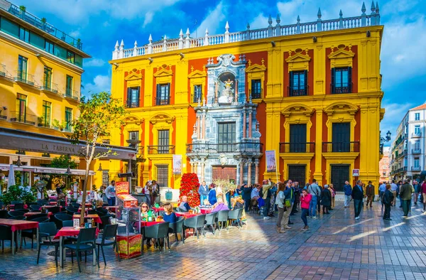 MALAGA, SPAIN, JANUARY 4, 2016: İnsanlar Malaga Plaza del Obispo 'daki Episkopal Sarayı' nın önündeki terasta otururken, Ocak ayında güneşli bir günün tadını çıkarıyorlar.