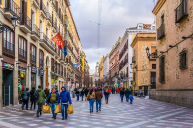 MADRID, SPAIN, JANUARY 9, 2016: people are strolling over calle de arenal towards puerta del sol square in the spanish capital madrid