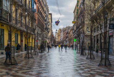 MADRID, SPAIN, JANUARY 10, 2016: people are strolling over calle de arenal towards puerta del sol square in the spanish capital madrid
