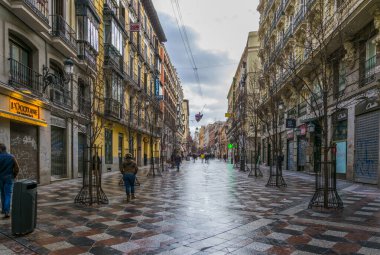MADRID, SPAIN, JANUARY 10, 2016: people are strolling over calle de arenal towards puerta del sol square in the spanish capital madrid