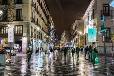 MADRID, SPAIN, JANUARY 9, 2016: people are strolling through calle del arenal in madrid during night