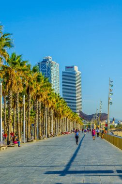 BARCELONA, SPAIN, OCTOBER 25,2014: People are strolling over Barceloneta promenade in Barcelona, Spain