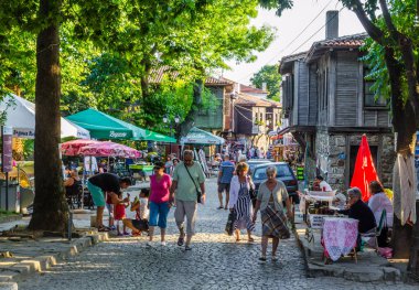 SOZOPOL, BULGARIA, JULY 17, 2015: The streets of the old city resort of Sozopol in Bulgaria are full of tourist during summer. Old town is famous for its distinctive wooden architecture, typical for bulgarian medieval age.