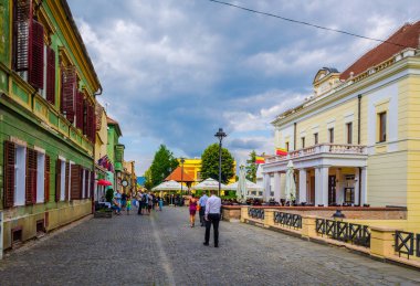 SIBIU, ROMANIA, 6 Temmuz 2015: Kimliği belirsiz insanlar Sibiu şehrindeki ortaçağ savunma duvarı ve Marangozlar Kulesi boyunca geziniyor.
