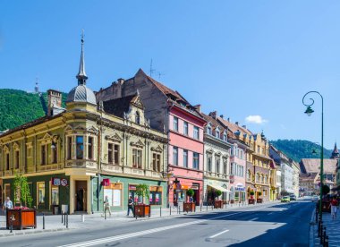 BRASOV, ROMANIA, 9 Temmuz 2015: Romanya 'nın Brasov kentindeki belediye binasının parlayan kulesiyle George Baritiu caddesinin manzarası.
