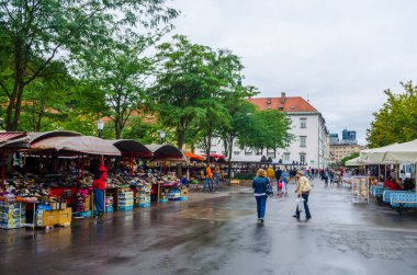 LJUBLJANA, SLOVENIA, JULY 29, 2015: People are strolling among stands in the central market of the slovenian capital ljubljana and buy various products often from local farmers.
